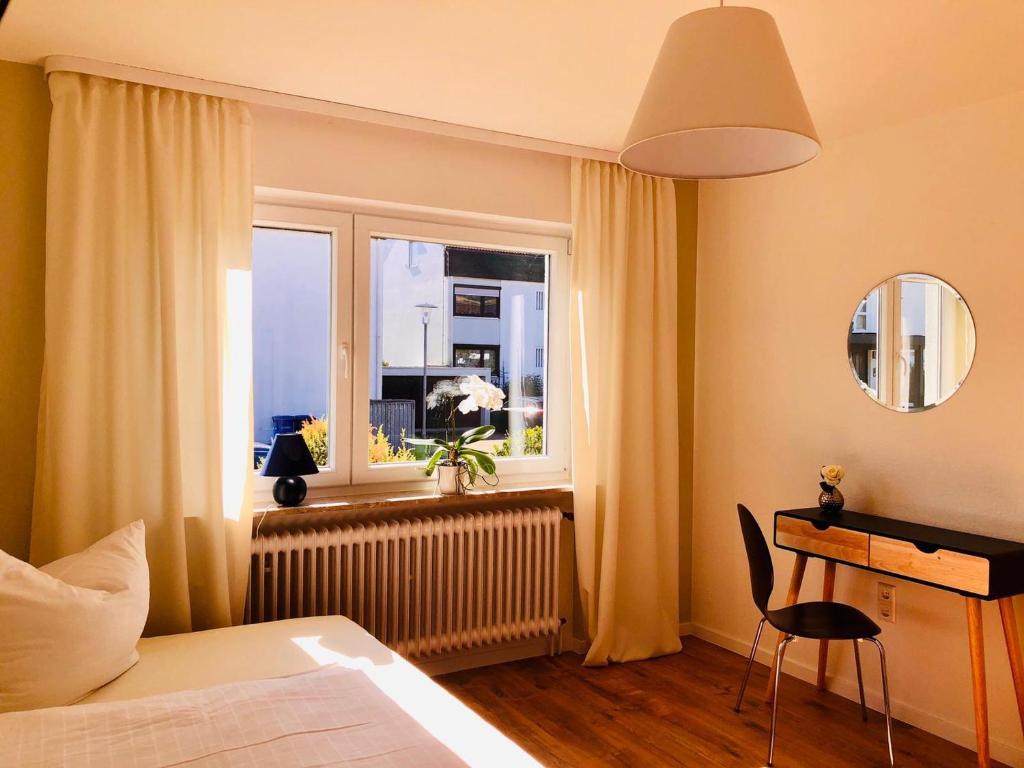 a bedroom with a bed and a window at Gästezimmer am Hochrhein in Lauchringen