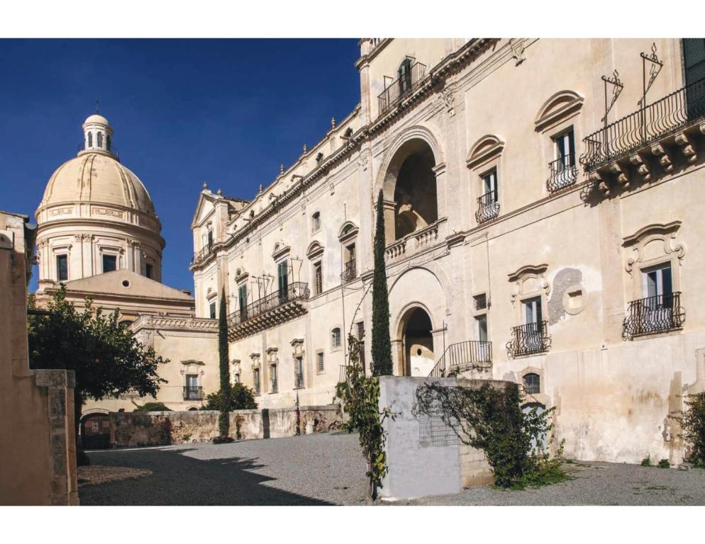 a large building with a dome on top of it at PALAZZO TRIGONA DEPENDANCE in Noto