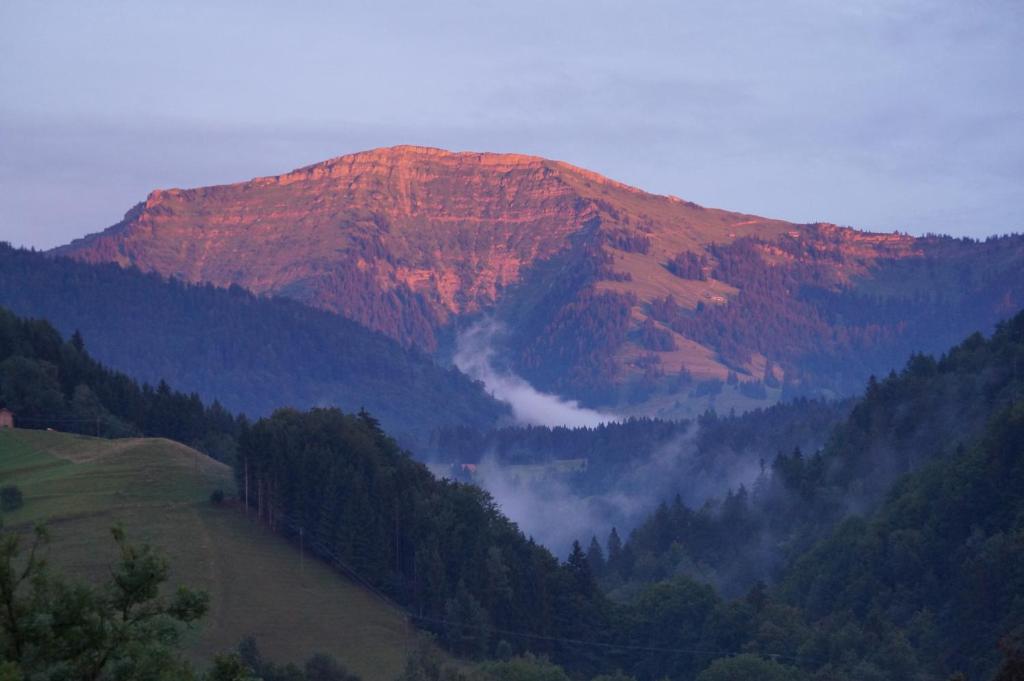 a mountain with a fog in front of it at Haus Hochgrat in Oberstaufen