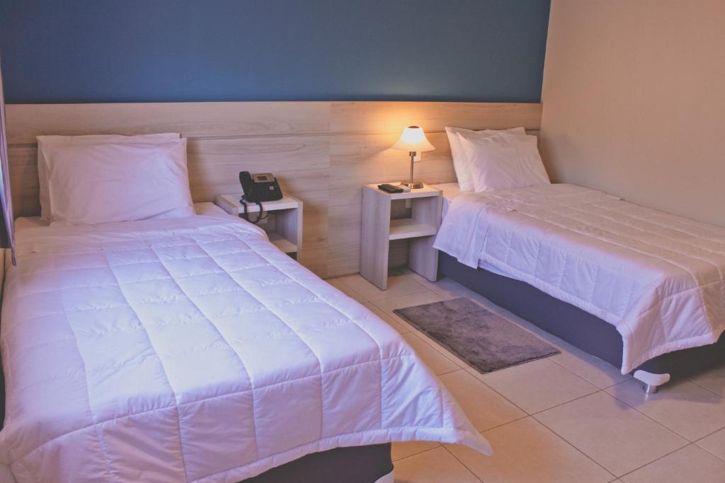 Postel nebo postele na pokoji v ubytování Nova Hotel
