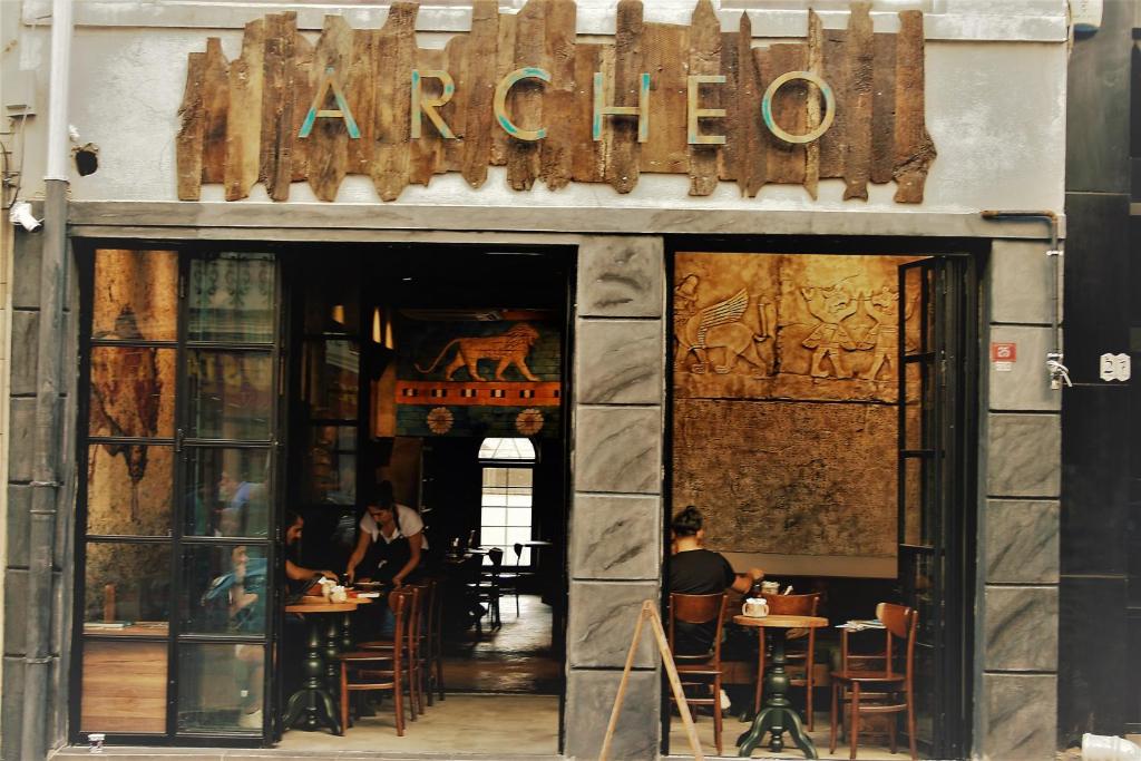a restaurant with people sitting at tables in the doorway at Archeo in Istanbul