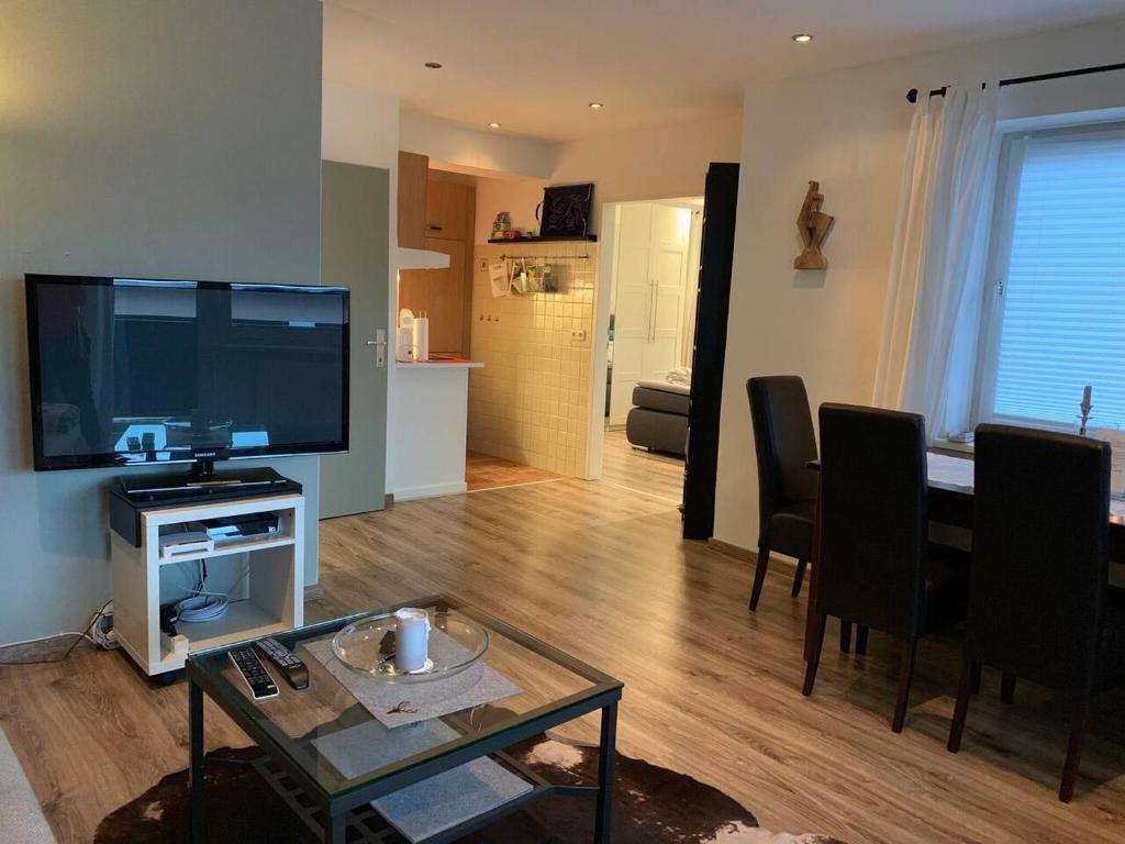 a living room with a large television and a table at Hornhaus in Kitzbühel