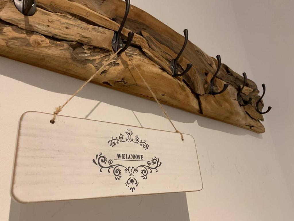a wooden sign hanging from a wooden stick at Hornhaus in Kitzbühel
