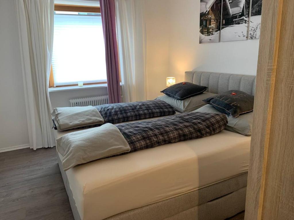 two beds sitting next to a window in a room at Hornhaus in Kitzbühel
