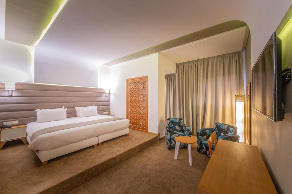 Postel nebo postele na pokoji v ubytování Hôtel Ibn Batouta