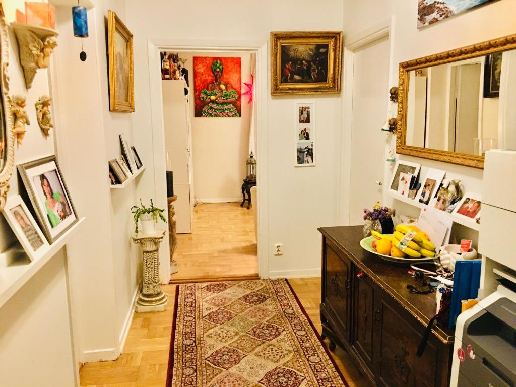 a hallway of a home with art on the walls at Room at Stockholm - Sweden in Stockholm
