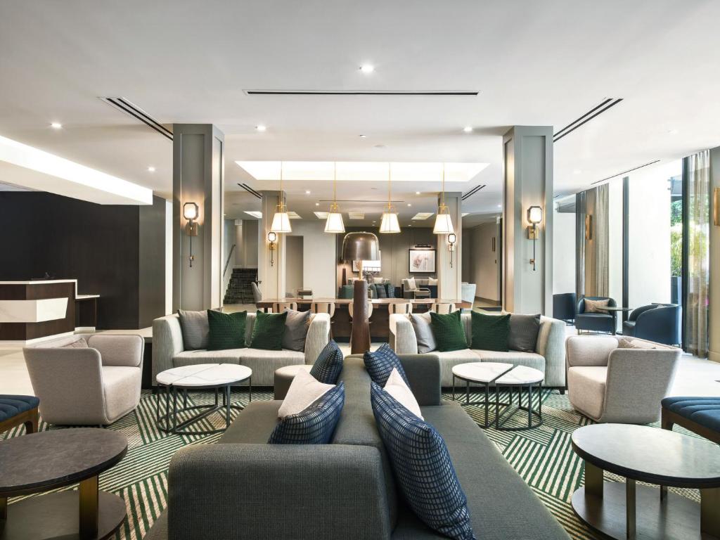 a hotel lobby with couches and tables at Riu Plaza Fisherman's Wharf in San Francisco