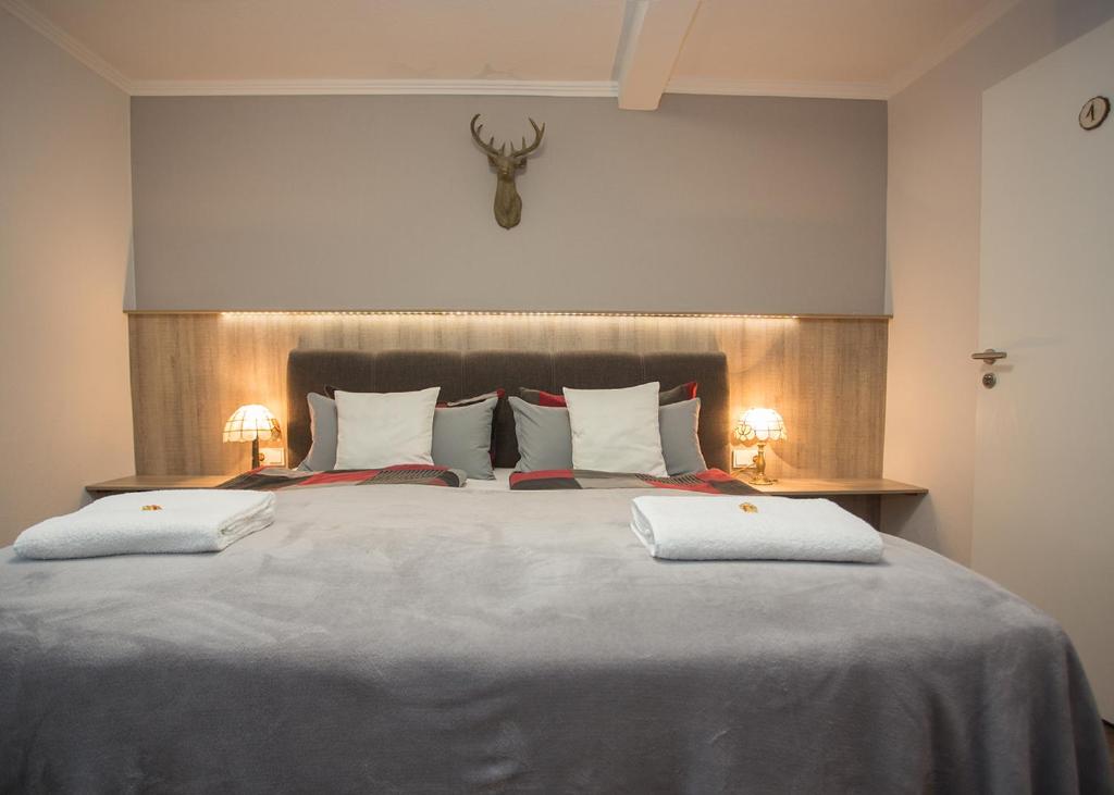 a bedroom with a large bed with two white pillows at Haus Jungmann in Hallenberg