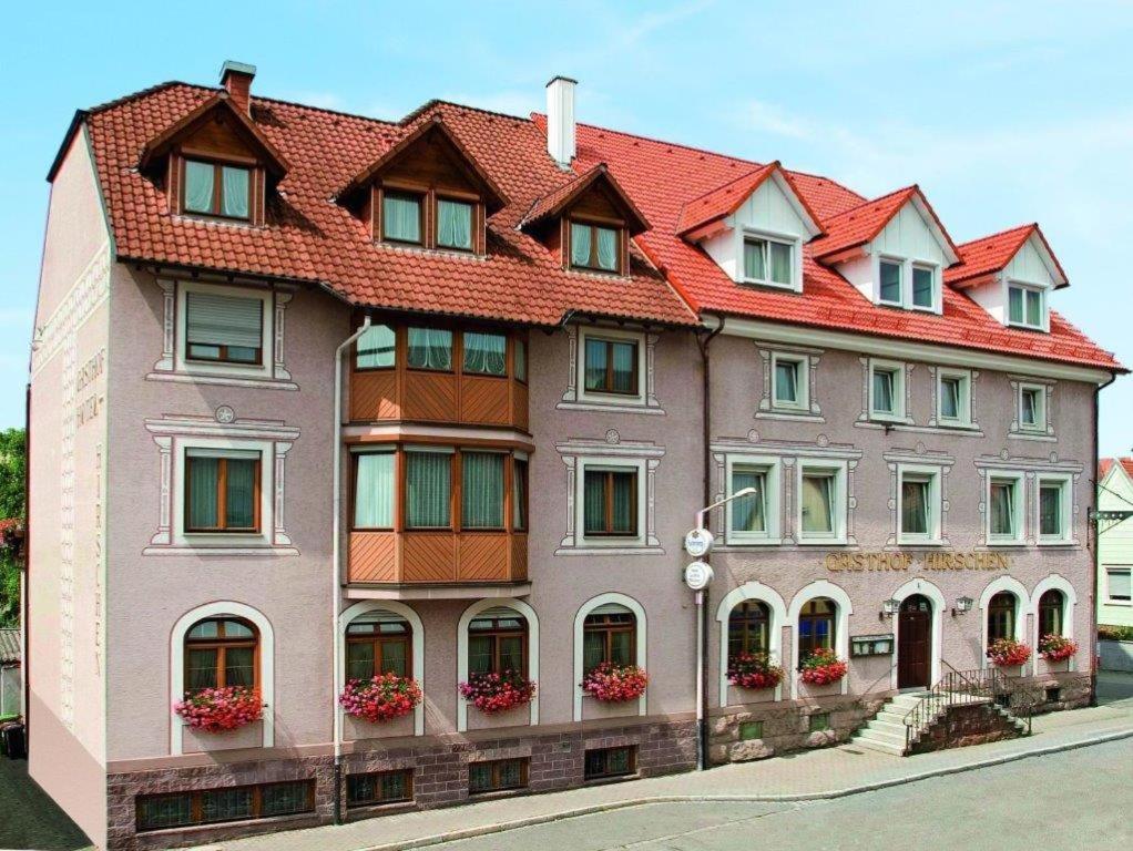 a large brick building with a large window at Hotel Restaurant Zum Hirschen in Donaueschingen