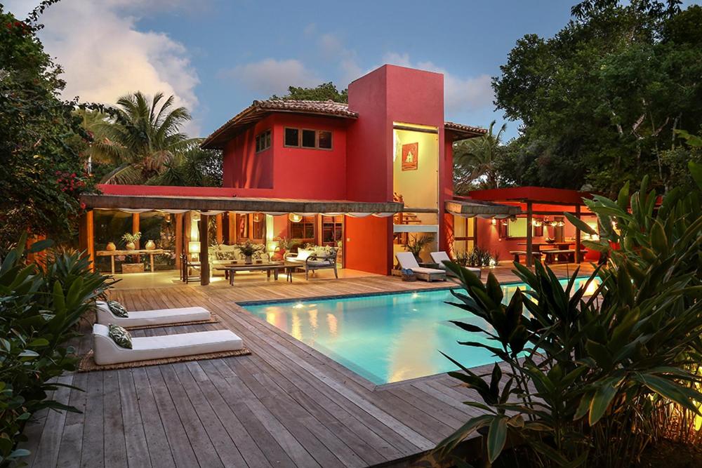 a house with a swimming pool in front of a house at Villa Vermelha - Altos de Trancoso in Trancoso