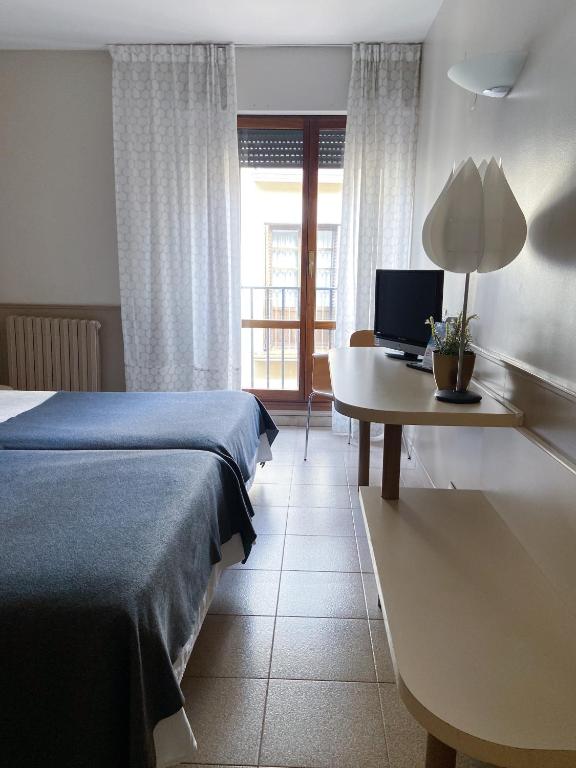 Postel nebo postele na pokoji v ubytování Hotel Rio Arga