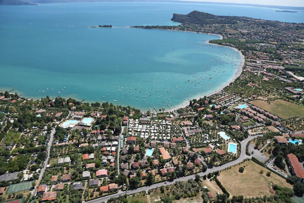 an aerial view of a city and a beach at Villenpark Sanghen in Manerba del Garda