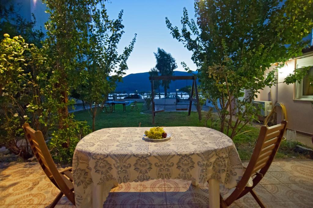 a table with a plate of food on it at Villa Elli 2 Beach-front villa with garden in Itea