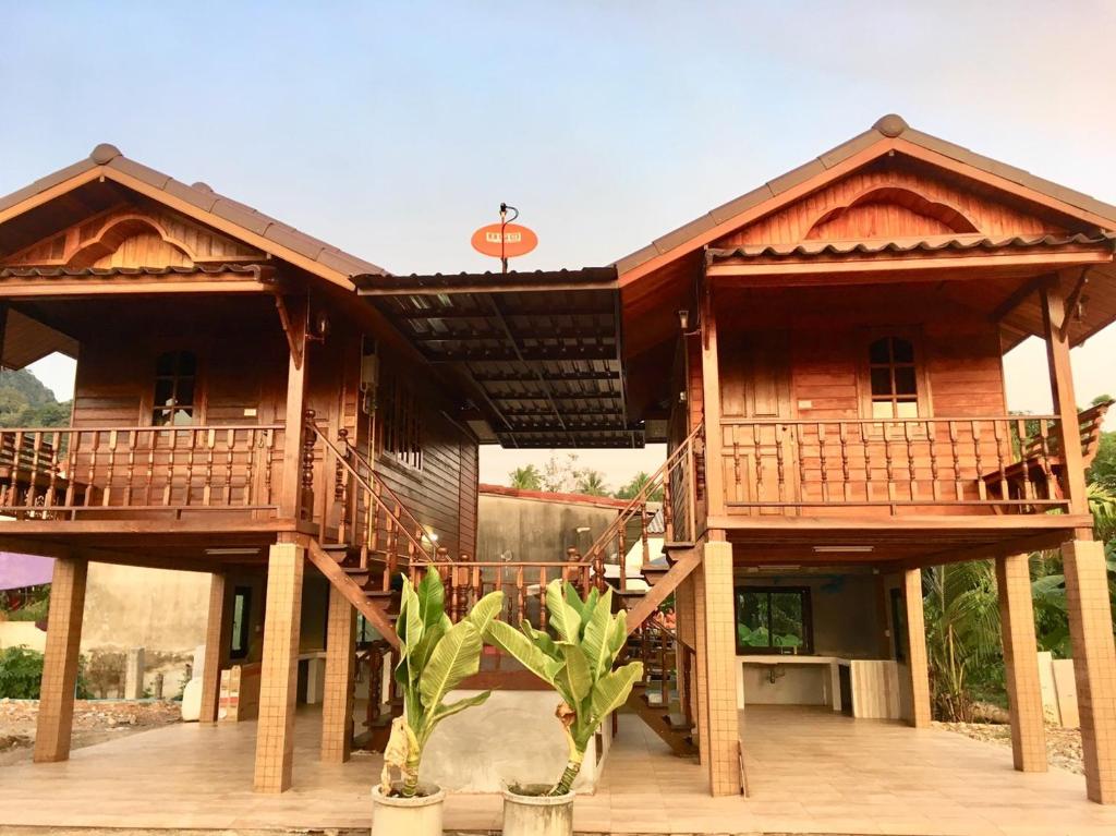 a large wooden house with two decks at Life and Love house in Ban Na Noi