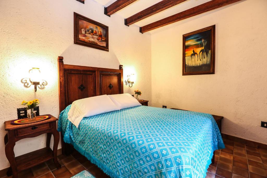 Postel nebo postele na pokoji v ubytování El mesón del Quijote