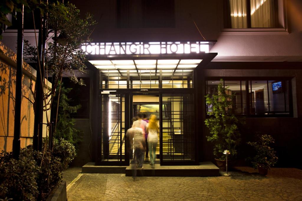 a couple standing outside of a hotel at night at Cihangir Hotel in Istanbul