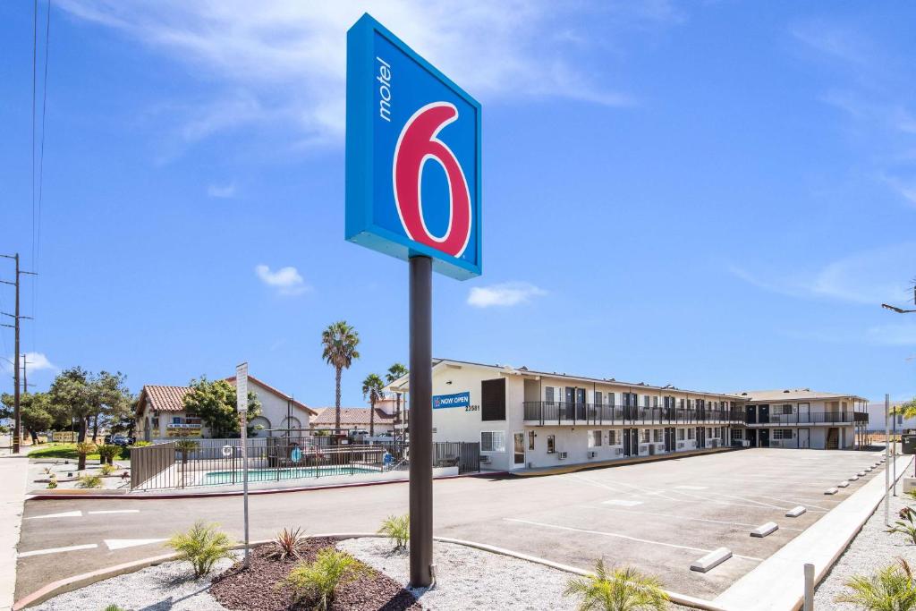 a sign in a parking lot in front of a hotel at Motel 6-Moreno Valley, CA - Perris in Moreno Valley