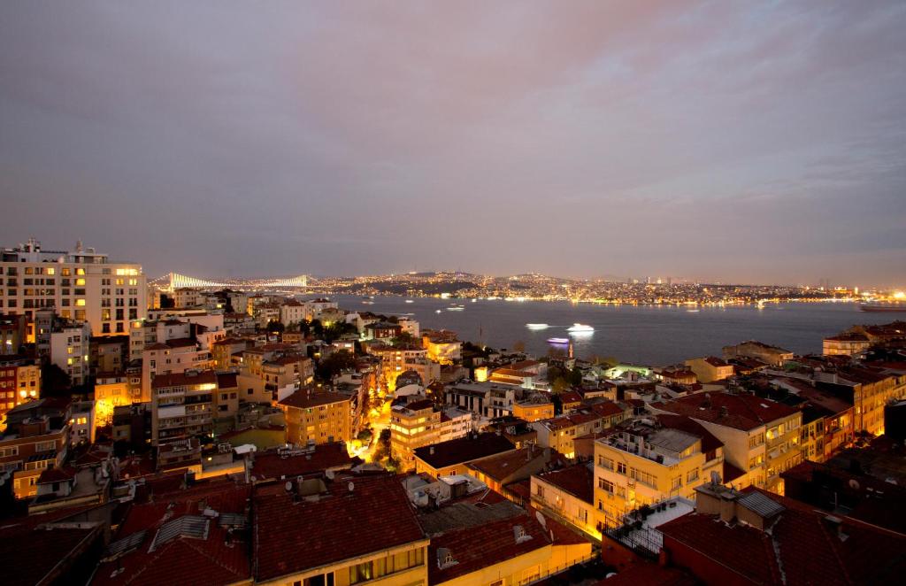 a view of a city at night at Cihangir Hotel Bosphorus in Istanbul