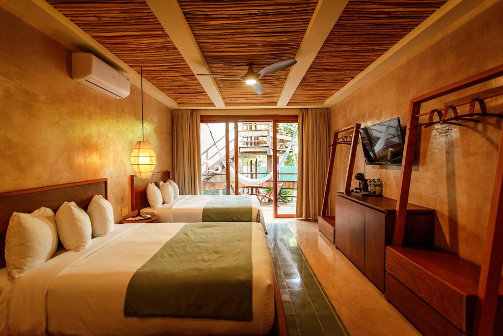 Postel nebo postele na pokoji v ubytování Hotel Carolina Bacalar