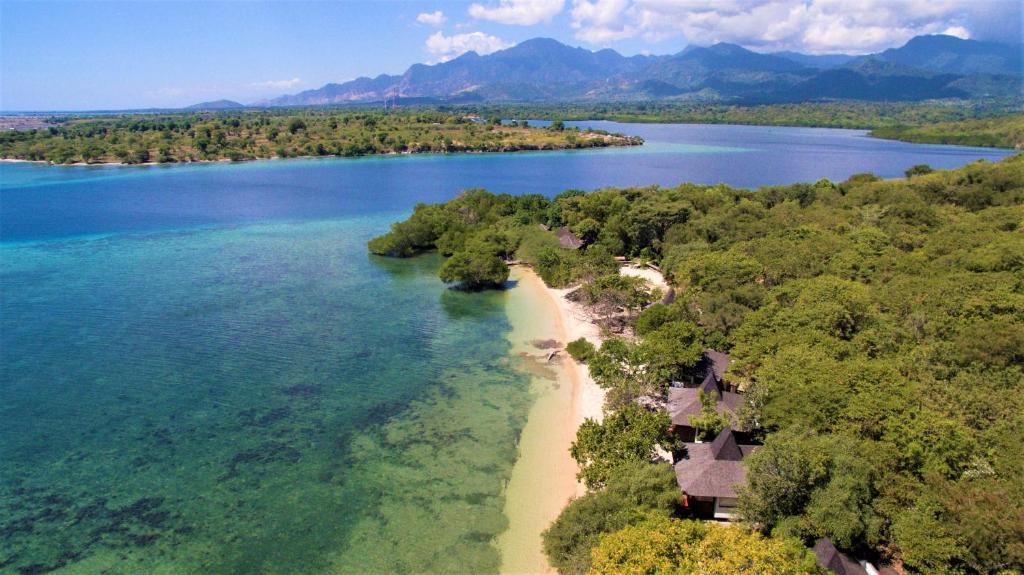 an aerial view of an island in a body of water at The Menjangan by LifestyleRetreats in Banyuwedang