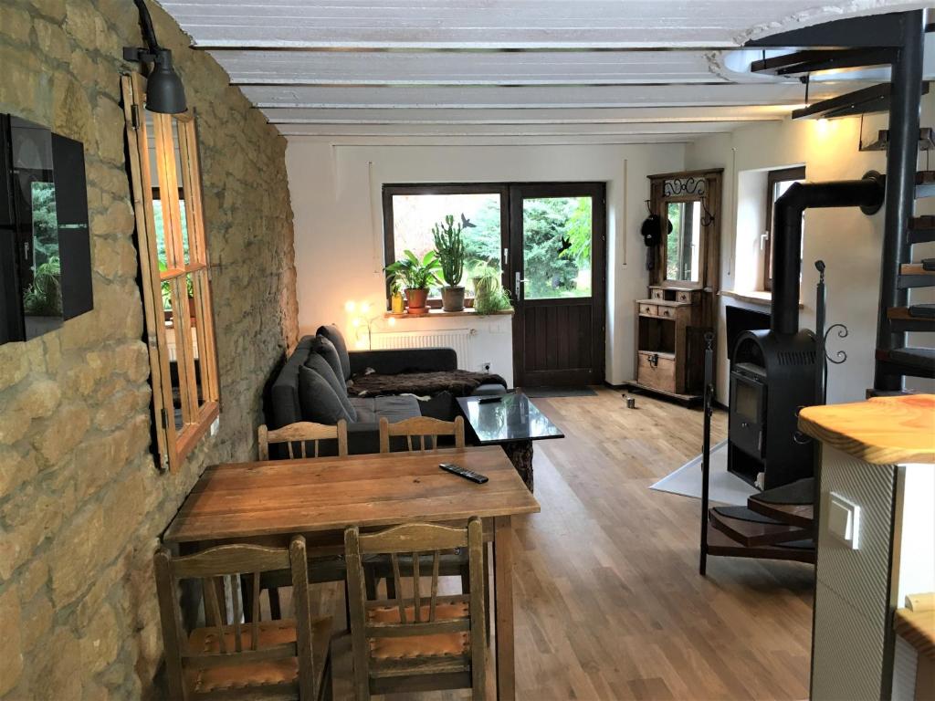 a living room with a couch and a table at Haus Rothenberg in Nohfelden