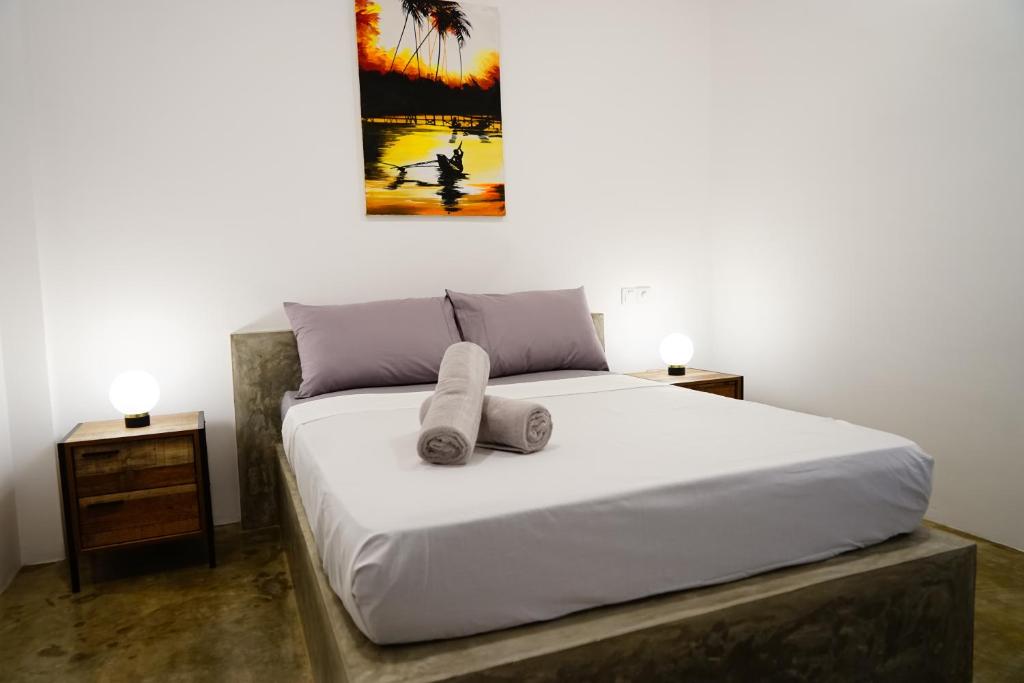 a bedroom with a large bed with two night stands at Island life in Negombo