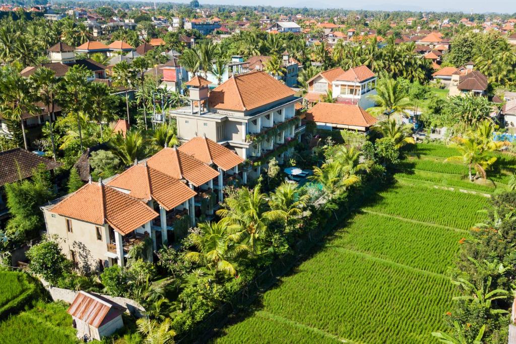 an aerial view of a house with palm trees at Kiskenda Cottages & Restaurant in Ubud