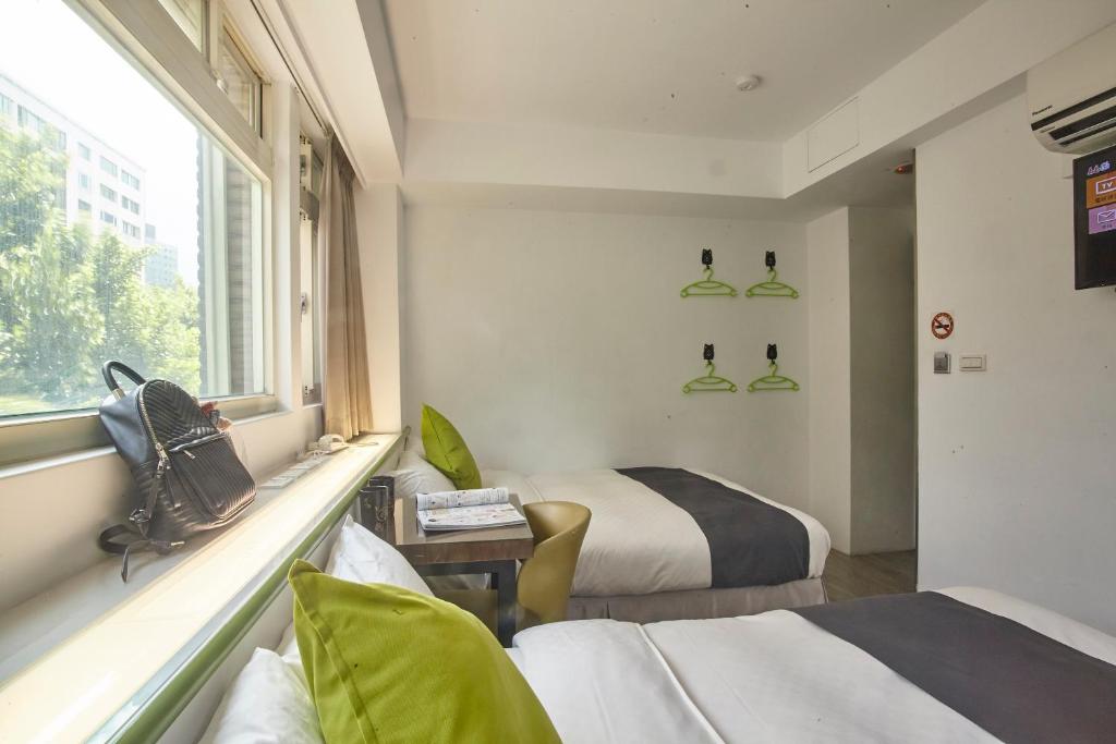 Postel nebo postele na pokoji v ubytování T.O. Hotel Chengde
