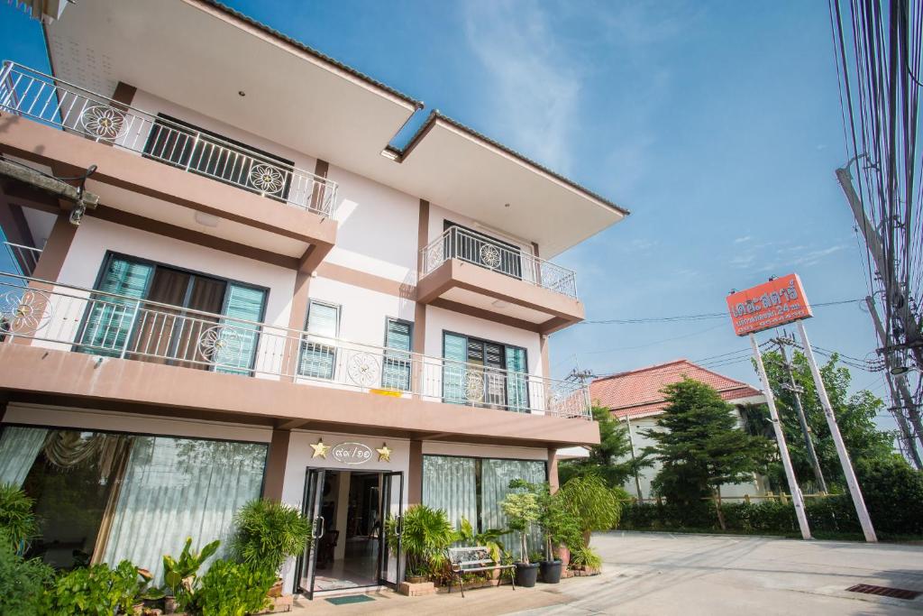 a large pink building with a balcony at The Star Hotel in Udon Thani