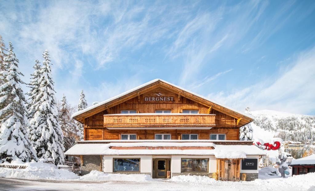 a log cabin in the winter with snow at Bergnest die Frühstückspension in Katschberghöhe