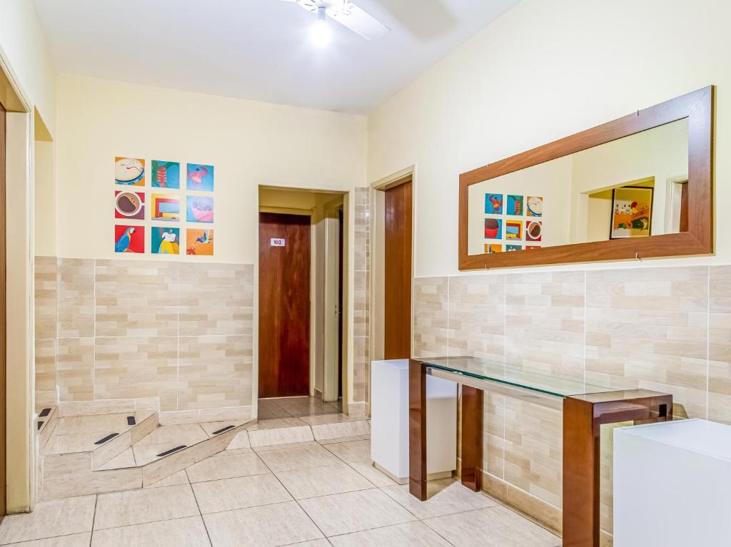 a bathroom with a glass counter and a mirror at Hotel Macuco in Sao Paulo