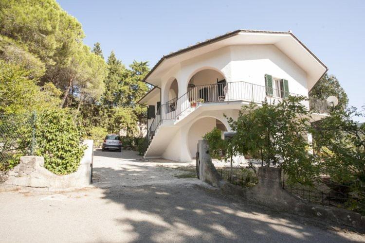 a house with a car parked in front of it at Villa Sibilla - Goelba in Procchio