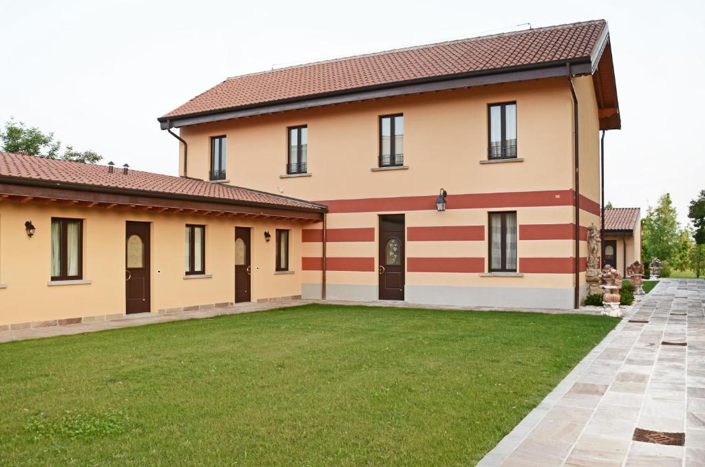 uma casa grande com um relvado em frente em Hotel Villa Borghesi em Corte dei Cortesi