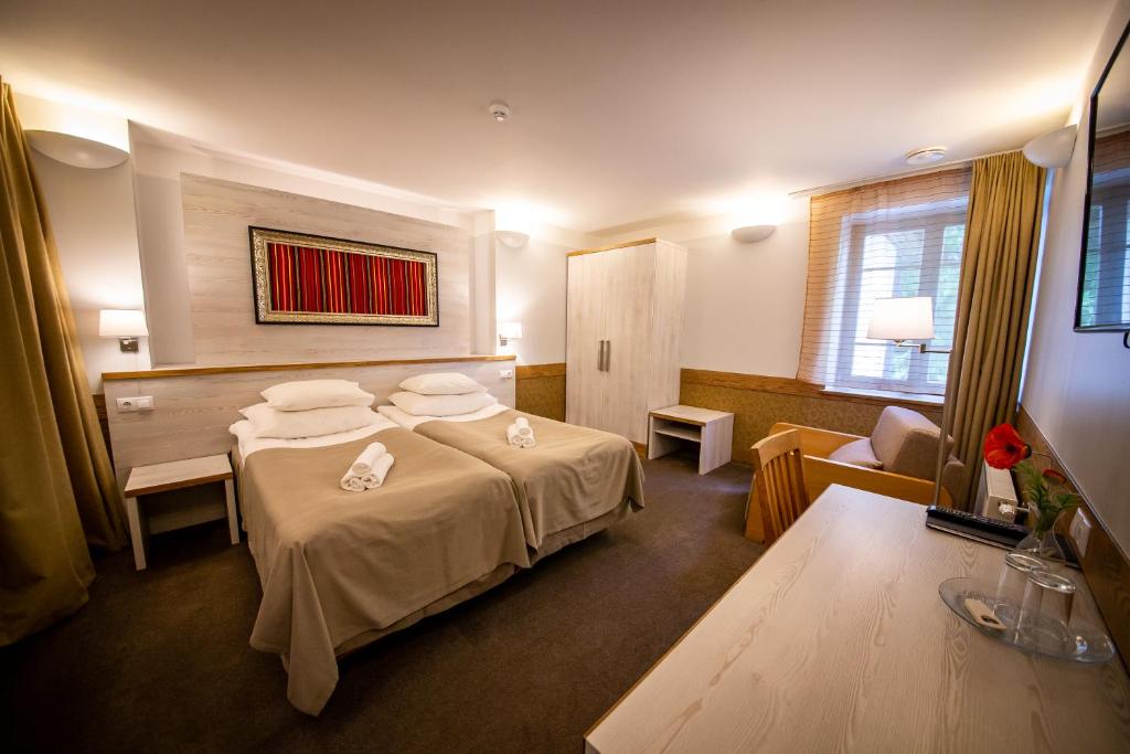Postel nebo postele na pokoji v ubytování Hotel Liilia