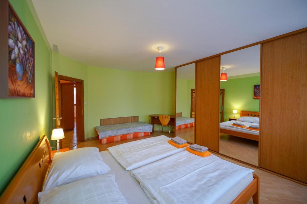 A bed or beds in a room at Penzion Fantazia Poprad - Self check-in
