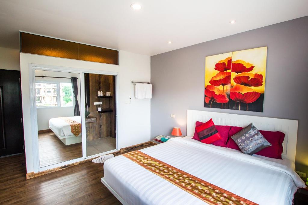 Giường trong phòng chung tại Queen Boutique Hotel Chaweng