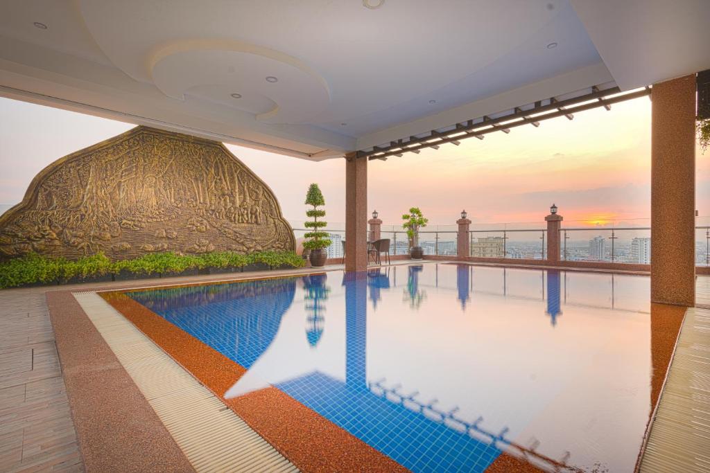 a swimming pool in a building with a dome at Queen Mansion in Phnom Penh