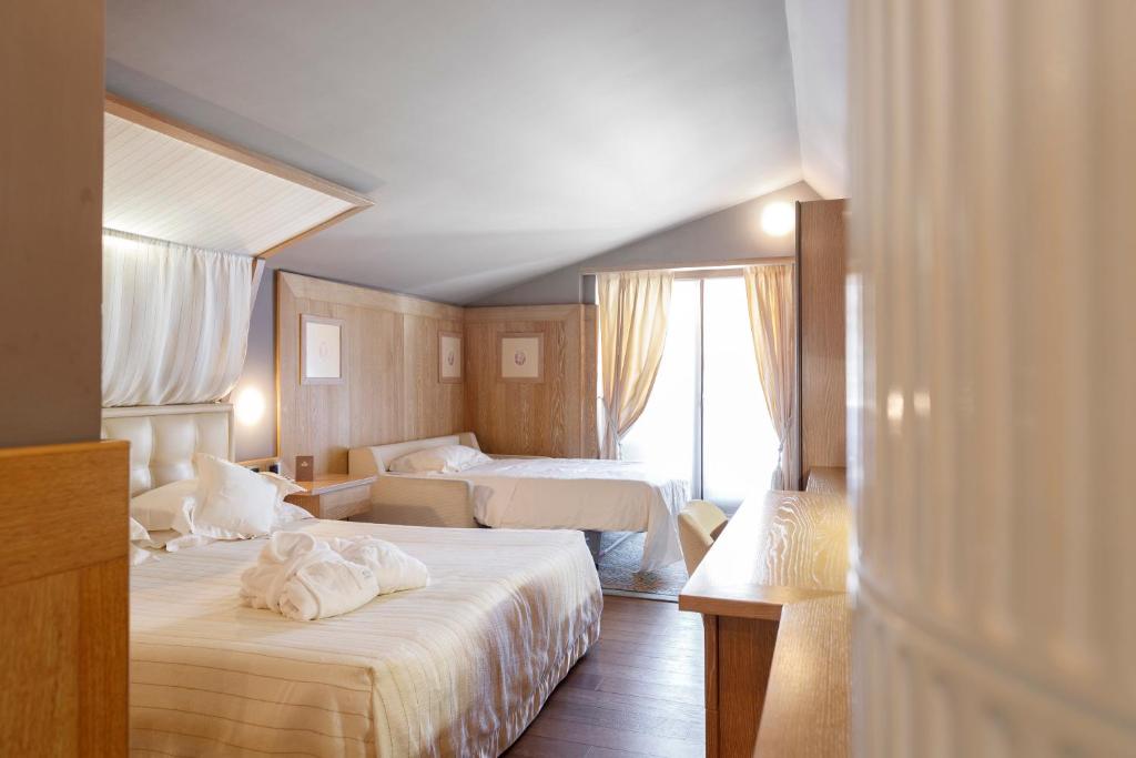 A bed or beds in a room at Hotel Spinale