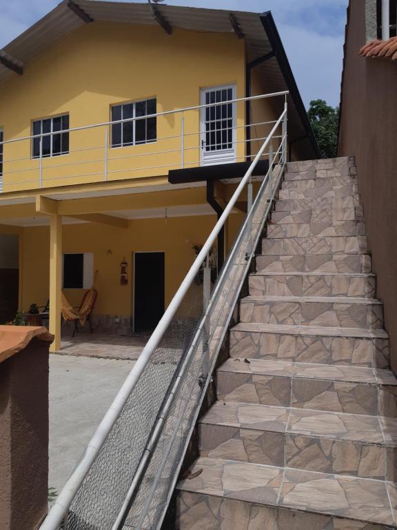 uma escada que leva a uma casa amarela em Recanto da Nice em Paraty