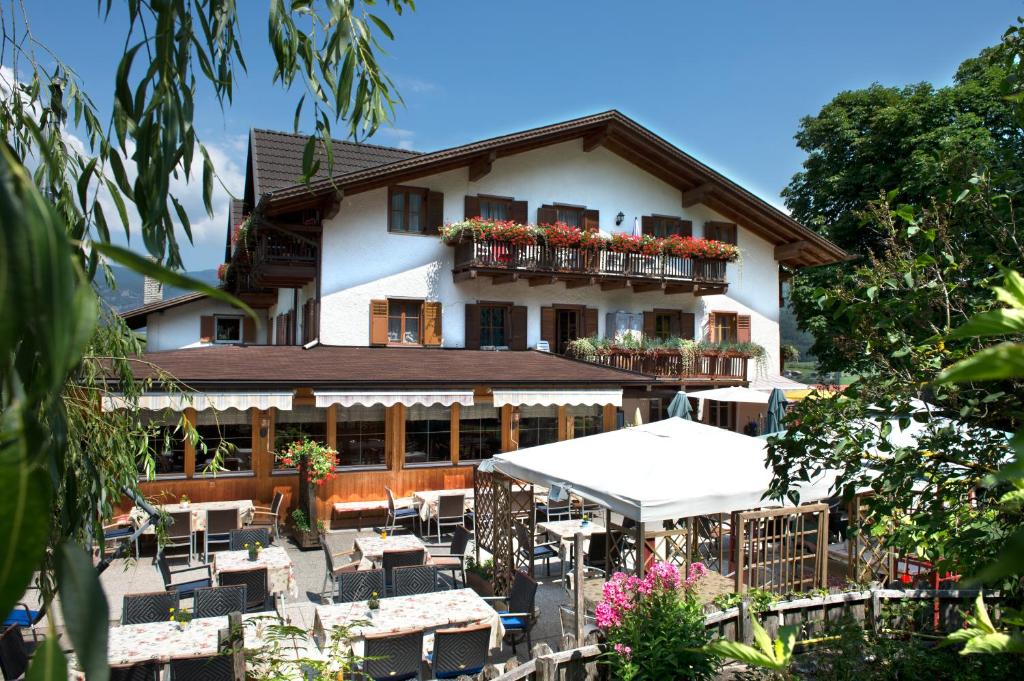 a building with tables and chairs in front of it at Gasthof zum Schlern in Völs am Schlern