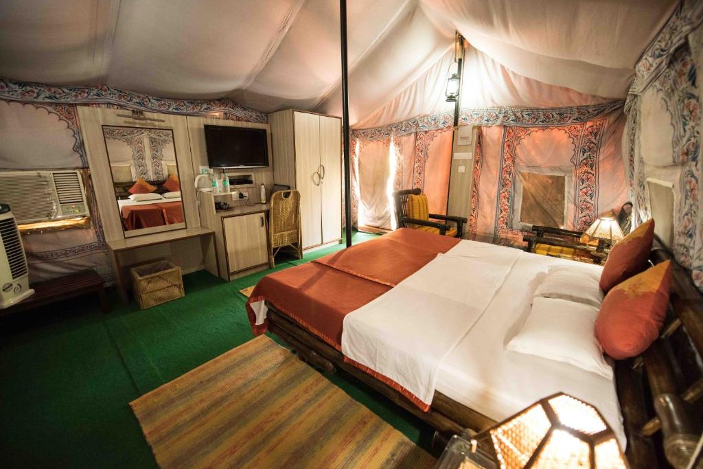 a bedroom with a large bed in a tent at Zizina Otis Resort in Guwahati