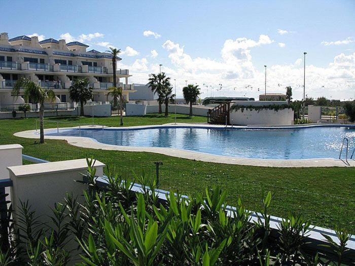 a swimming pool in the middle of a resort at Casa Valdevaqueros in Tarifa