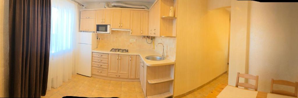 a kitchen with white cabinets and a sink in it at LvivBalabana in Lviv