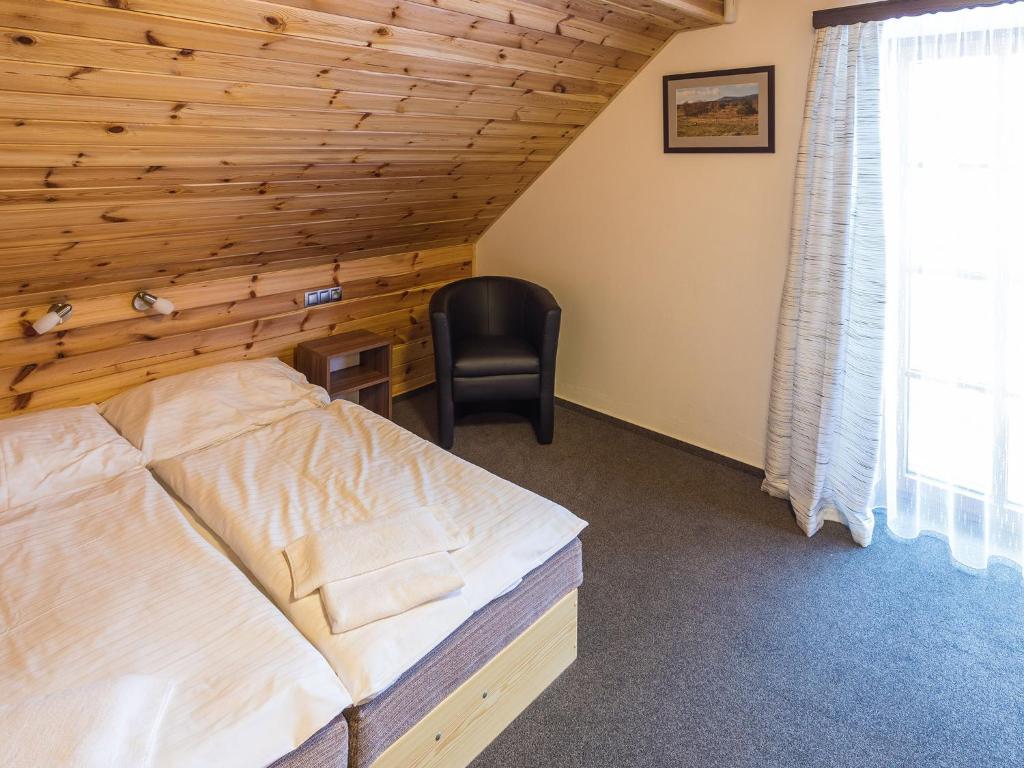 Łóżko lub łóżka w pokoju w obiekcie EA Horský Hotel Hájenka