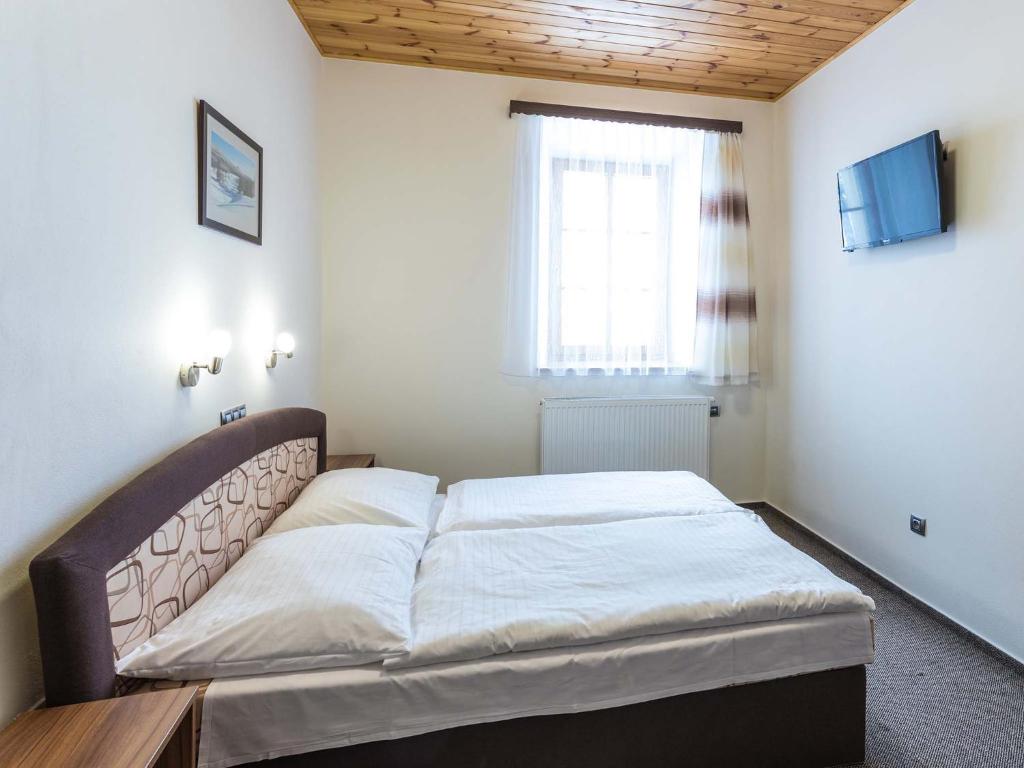 Łóżko lub łóżka w pokoju w obiekcie EA Horský Hotel Hájenka
