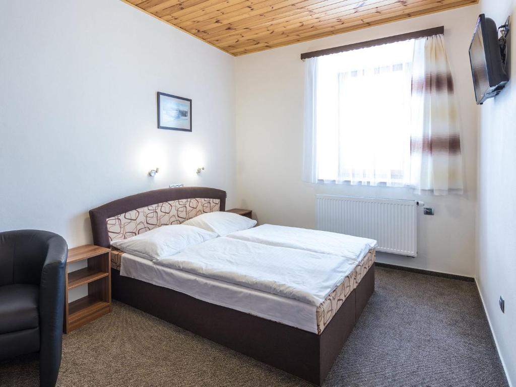 Łóżko lub łóżka w pokoju w obiekcie EA Horský Hotel Hájenka
