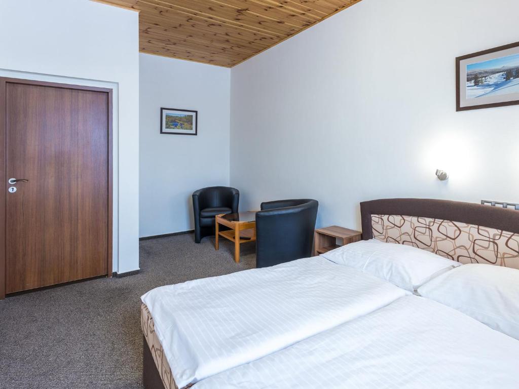 Łóżko lub łóżka w pokoju w obiekcie EA Horský Hotel Hájenka