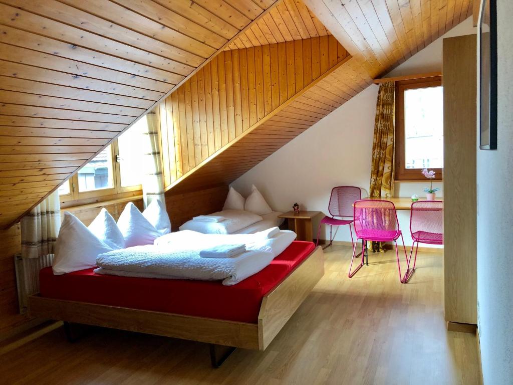 a bedroom with a bed with white pillows at central beauty scenery apartment in Interlaken
