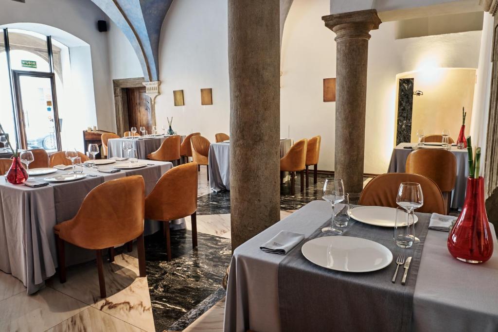a restaurant with tables and chairs in a room at Hotel Stary in Kraków