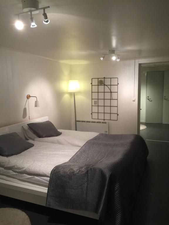 a bedroom with a large bed with a light on it at Lägenhet centralt i Värnamo vid Apladalen in Värnamo